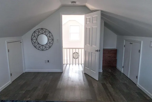 a view of a room with wooden floor and windows
