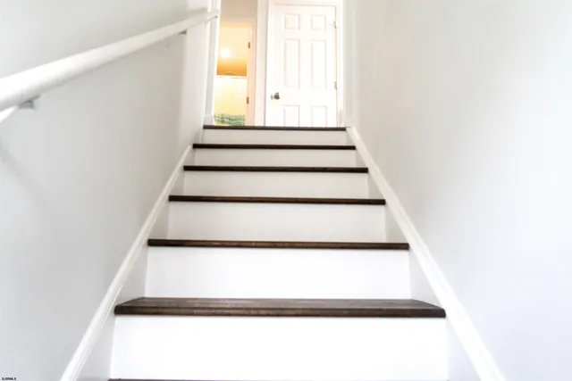 a view of staircase with white walls