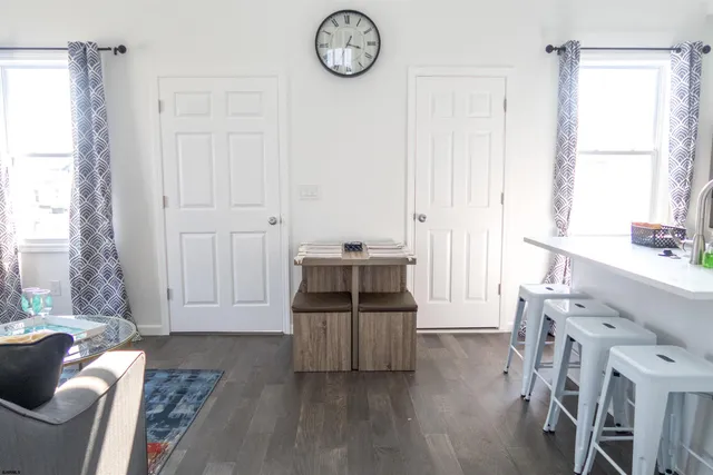 a living room with furniture a wooden floor and a window