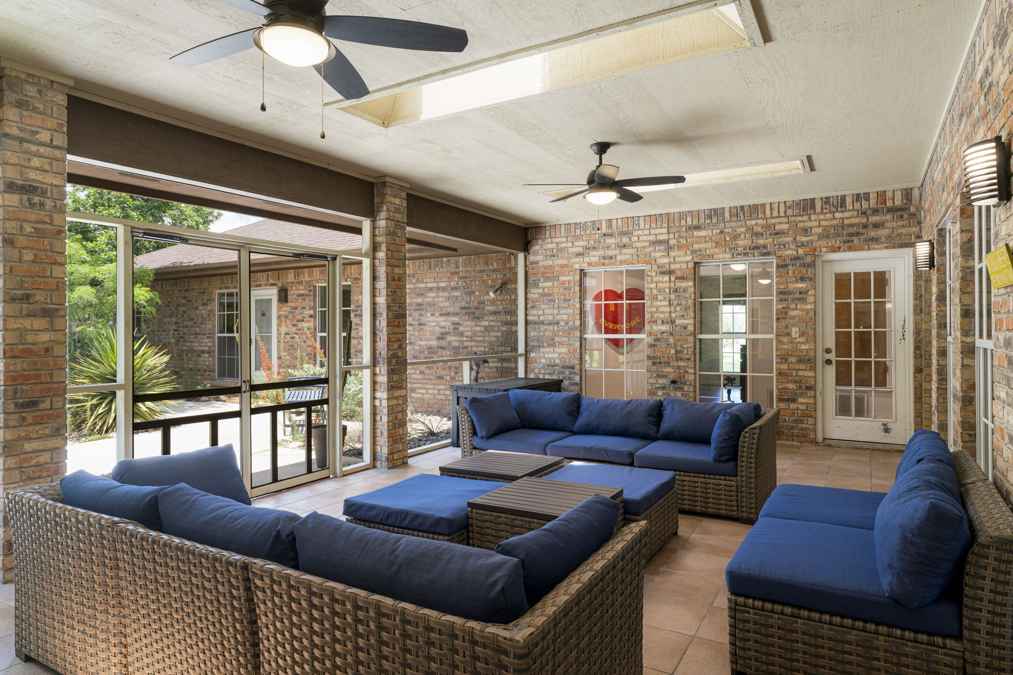 400 Hackberry Street Lockhart, TX 78644 - Photo 5 of 40 An inviting covered patio features a screened enclosure for year-round outdoor enjoyment.
