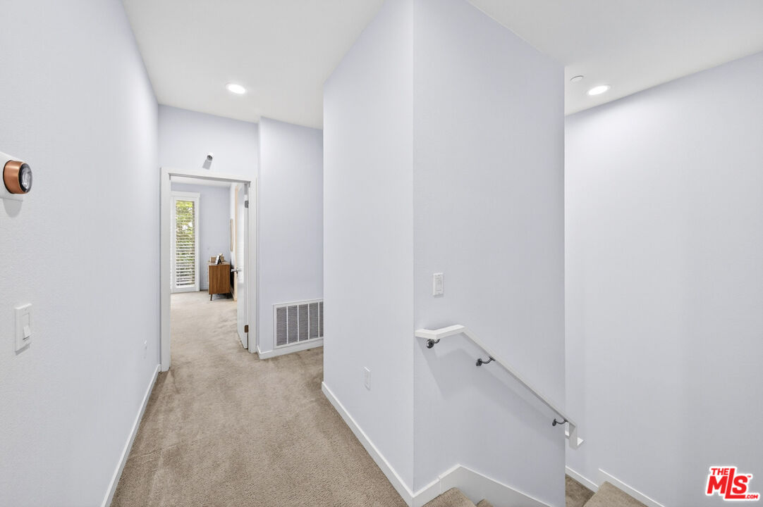 676 Colorado Circle Carson, CA 90745 - Photo 17 of 36 a view of a hallway with wooden floor and staircase