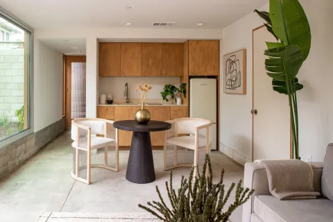 a kitchen with a table chairs and a chandelier