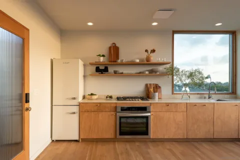 a kitchen with stainless steel appliances granite countertop a sink a stove and a refrigerator