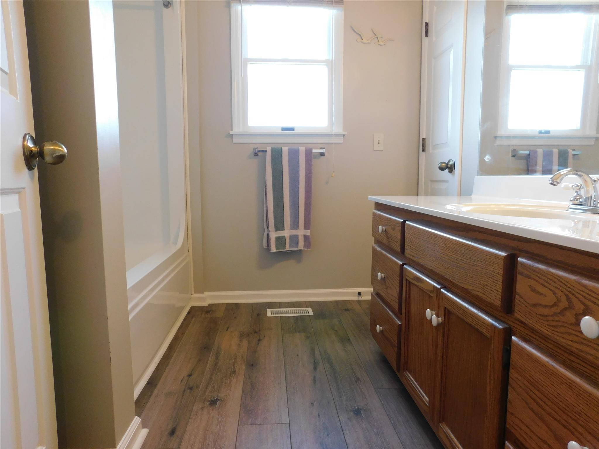 2470 Ben Green Road Lebanon, TN 37090 - Photo 22 of 24 a bathroom with a sink a mirror and wooden floor