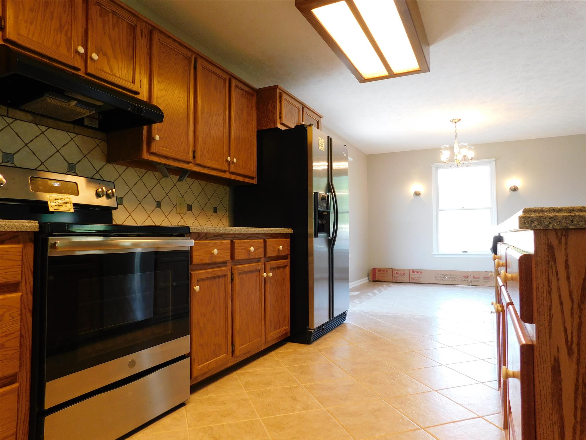 2470 Ben Green Road Lebanon, TN 37090 - Photo 9 of 24 a kitchen with stainless steel appliances granite countertop a refrigerator and a stove top oven