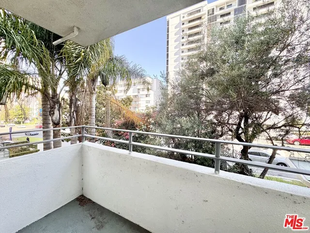 a view of a balcony with trees
