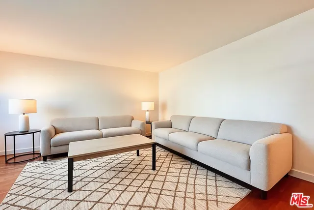 a living room with furniture and a lamp