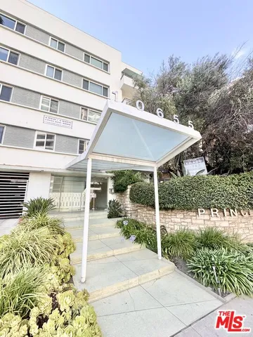 a view of a patio with table and chairs and potted plants
