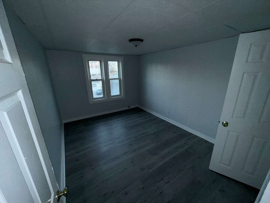 573 Main Street Southbridge, MA 01550 - Photo 13 of 15 an empty room with wooden floor and windows