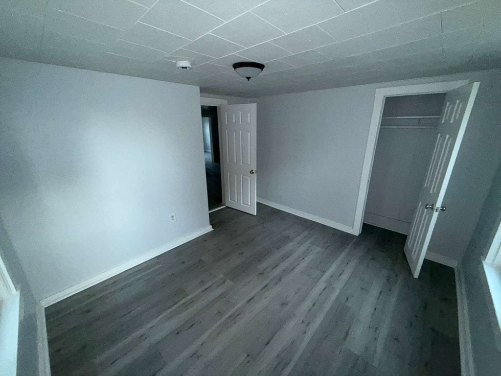 573 Main Street Southbridge, MA 01550 - Photo 14 of 15 an empty room with wooden floor and windows