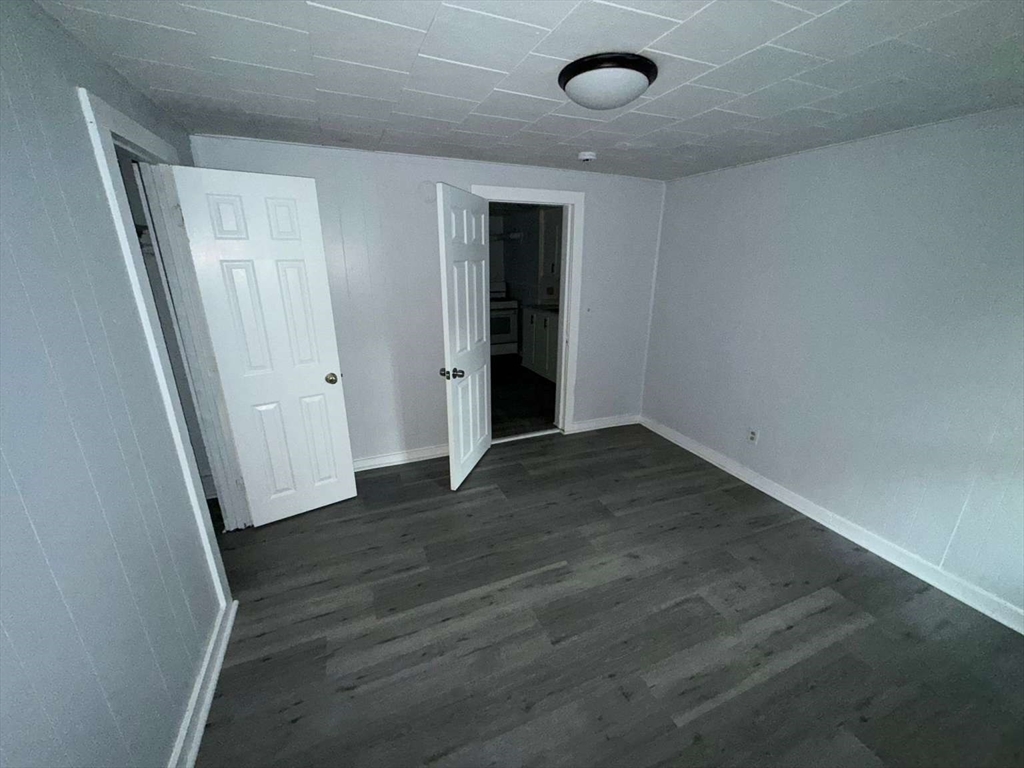 573 Main Street Southbridge, MA 01550 - Photo 15 of 15 an empty room with wooden floor and entrance