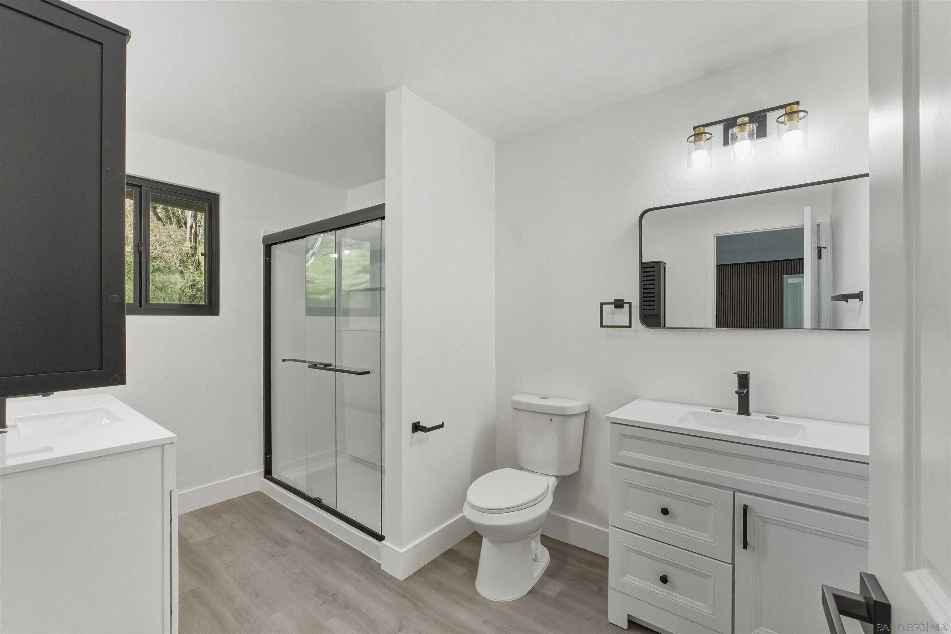 11618 Johnson Lake Road Lakeside, CA 92040 - Photo 12 of 25 a bathroom with a toilet a sink a mirror and a shower