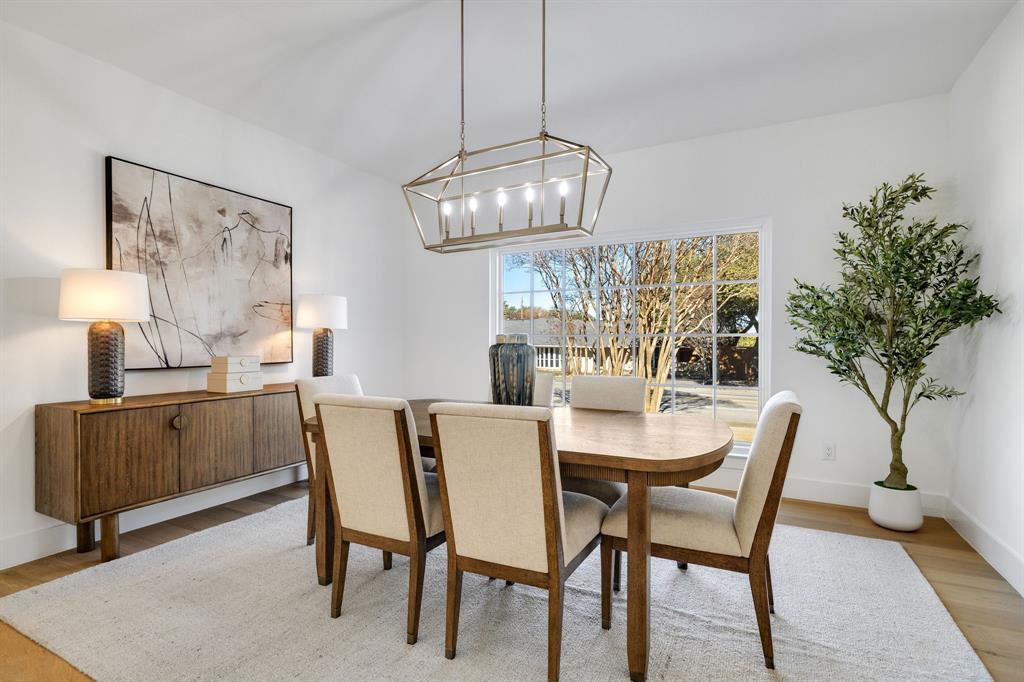 7124 Meadow Road Dallas, TX 75230 - Photo 11 of 39 a dining room with furniture a chandelier and window