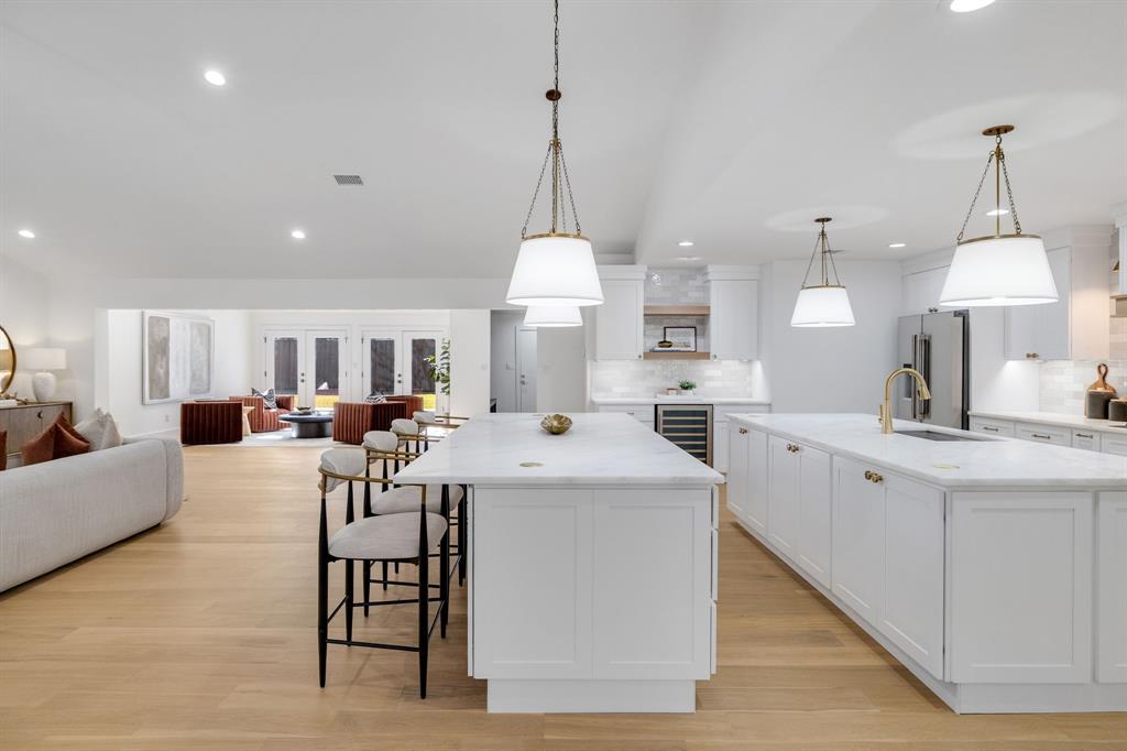 7124 Meadow Road Dallas, TX 75230 - Photo 13 of 39 a view of a kitchen and living room