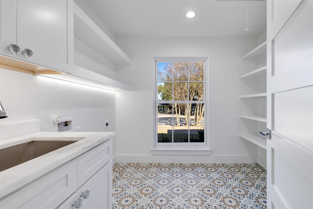 7124 Meadow Road Dallas, TX 75230 - Photo 16 of 39 a view of a bathroom with a sink and a window