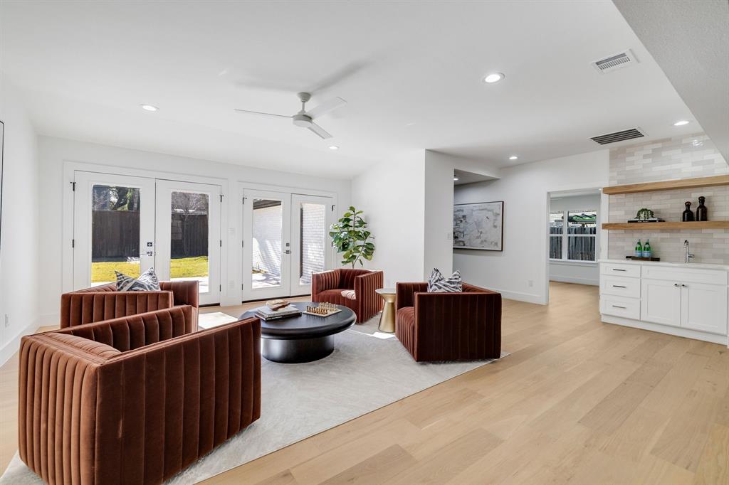 7124 Meadow Road Dallas, TX 75230 - Photo 20 of 39 a living room with furniture and wooden floor