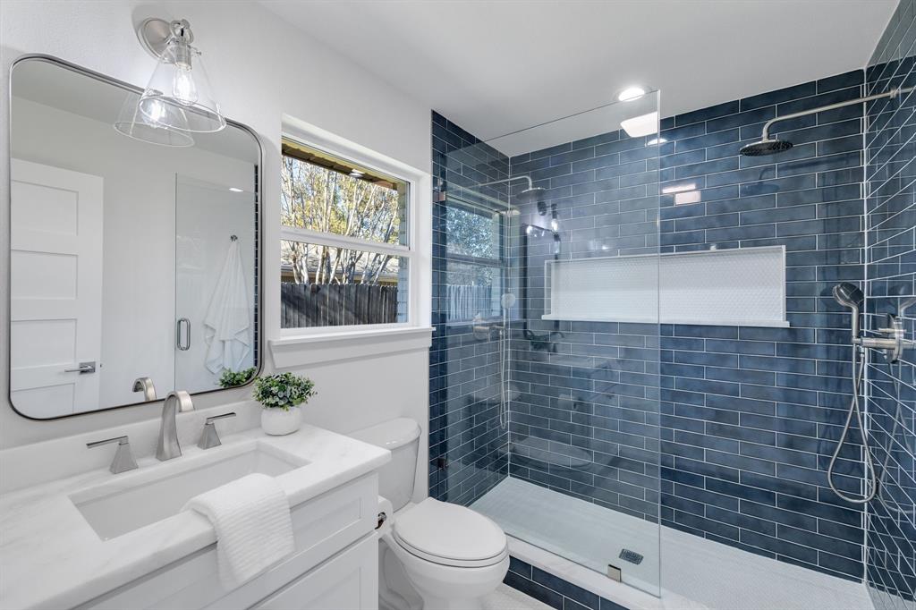 7124 Meadow Road Dallas, TX 75230 - Photo 23 of 39 a bathroom with a sink a toilet and shower