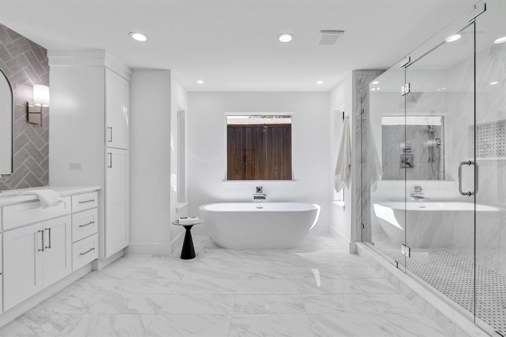 7124 Meadow Road Dallas, TX 75230 - Photo 30 of 39 a bathroom with a bathtub shower sink and mirror