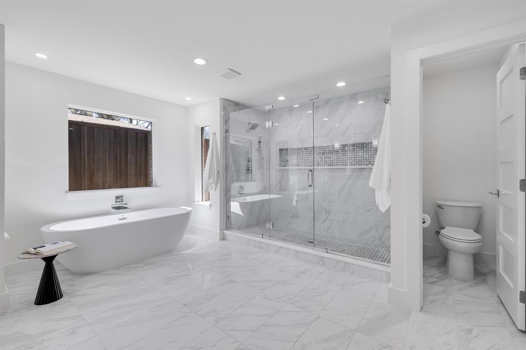 7124 Meadow Road Dallas, TX 75230 - Photo 32 of 39 a bathroom with a bathtub shower sink and toilet