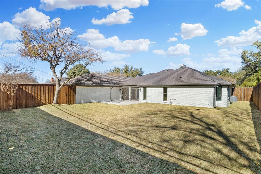 7124 Meadow Road Dallas, TX 75230 - Photo 36 of 39 a front view of a house with a yard and garage