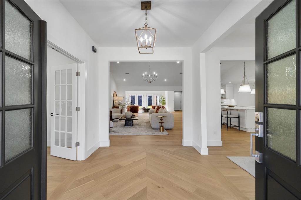 7124 Meadow Road Dallas, TX 75230 - Photo 4 of 39 a view of a livingroom with a dinning area hardwood floor and a bedroom