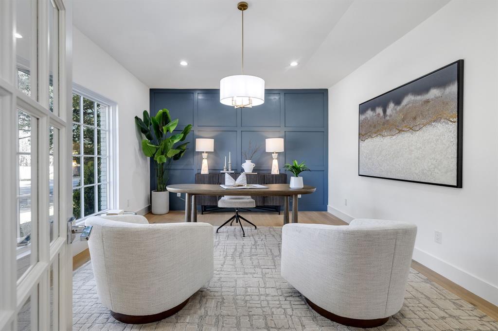 7124 Meadow Road Dallas, TX 75230 - Photo 6 of 39 a living room with couches a chandelier and a dining table with wooden floor