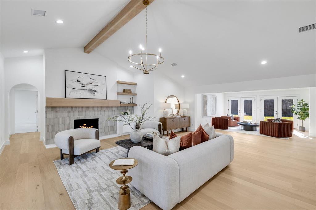 7124 Meadow Road Dallas, TX 75230 - Photo 8 of 39 a living room with furniture fireplace and a chandelier
