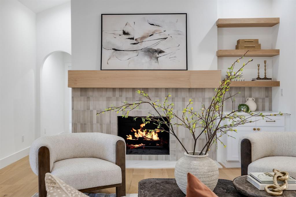 7124 Meadow Road Dallas, TX 75230 - Photo 9 of 39 a living room with furniture and a fireplace