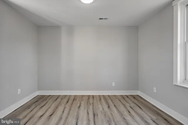 a view of an empty room and wooden floor