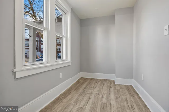 a view of a room with wooden floor and windows