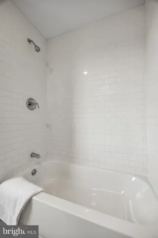 a bathroom with a bathtub and a toilet
