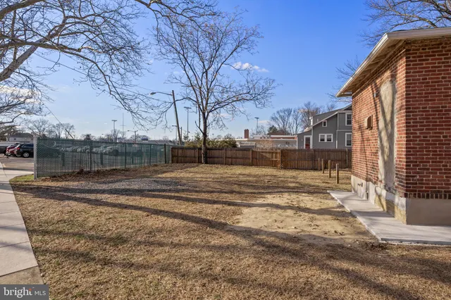 a view of a yard with snow on the road