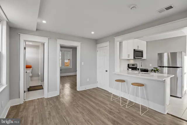 a kitchen with white cabinets and stainless steel appliances