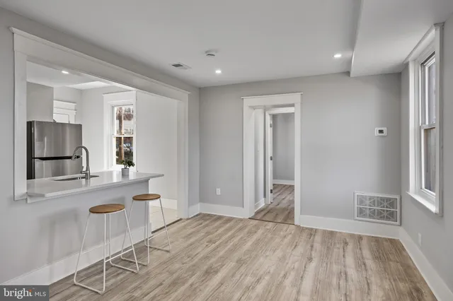 a view of a kitchen with a sink and a refrigerator