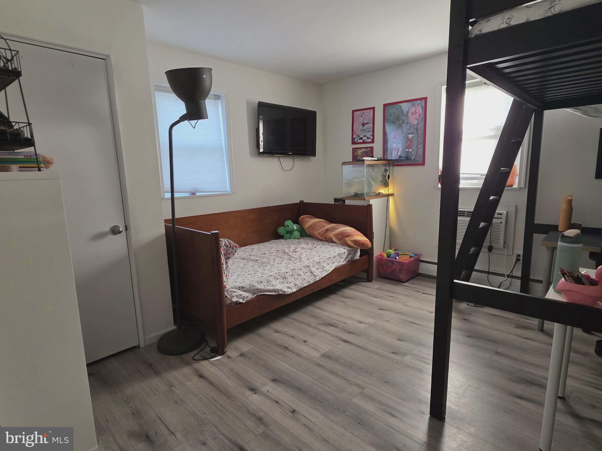 412 North Wayne Avenue, Unit 109 Wayne, PA 19087 - Photo 13 of 20 a living room with furniture and a flat screen tv