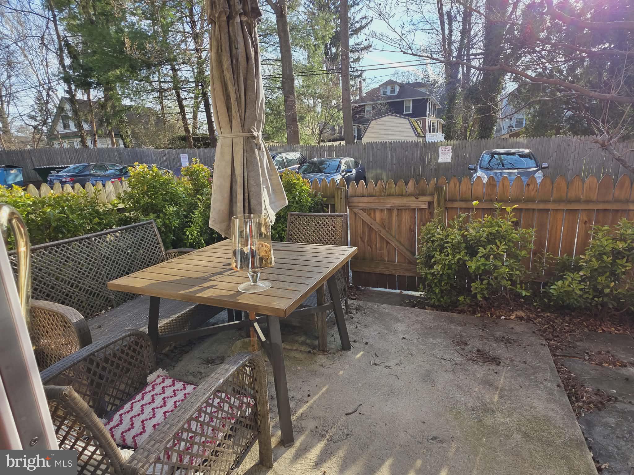 412 North Wayne Avenue, Unit 109 Wayne, PA 19087 - Photo 15 of 20 a view of a patio with table and chairs potted plants and a large tree