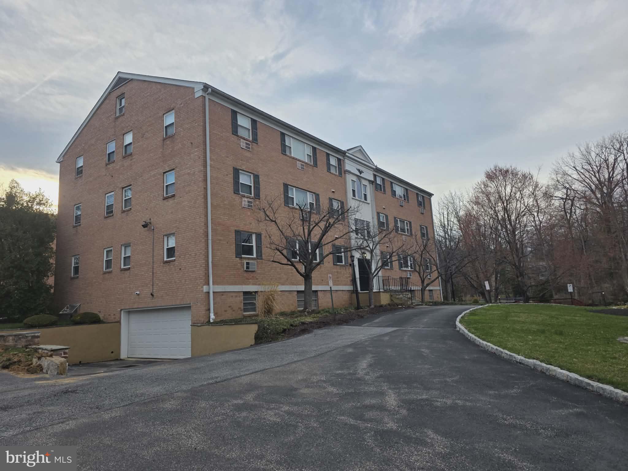 412 North Wayne Avenue, Unit 109 Wayne, PA 19087 - Photo 20 of 20 a front view of a building with garden