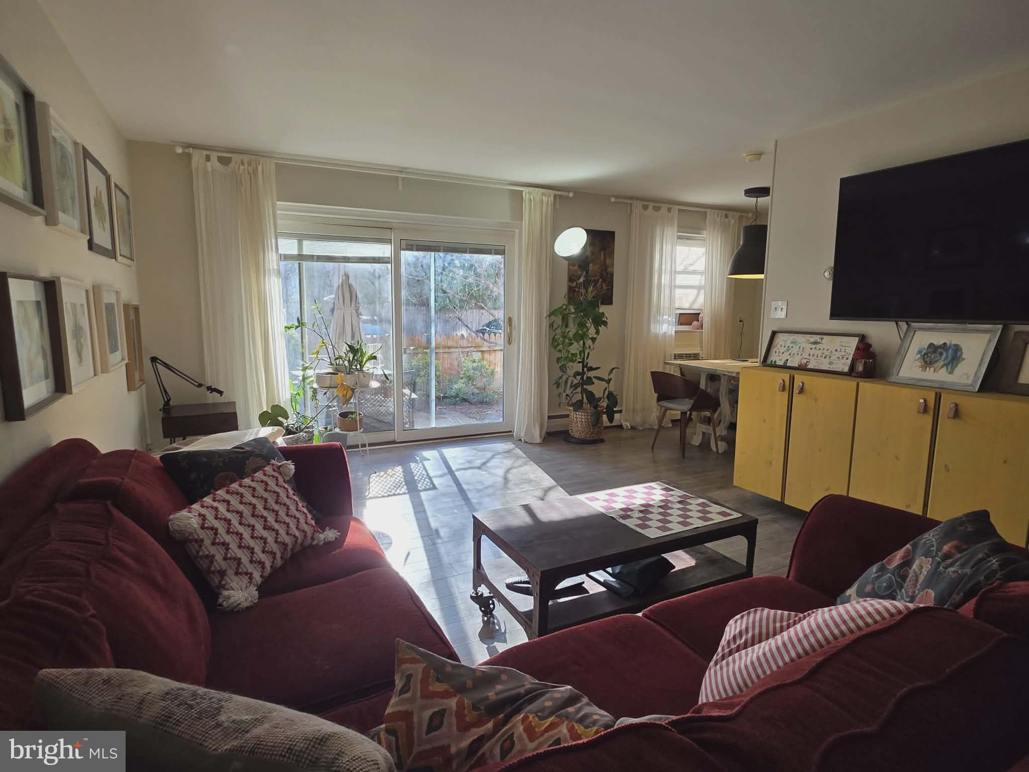 412 North Wayne Avenue, Unit 109 Wayne, PA 19087 - Photo 3 of 20 a living room with furniture and a flat screen tv