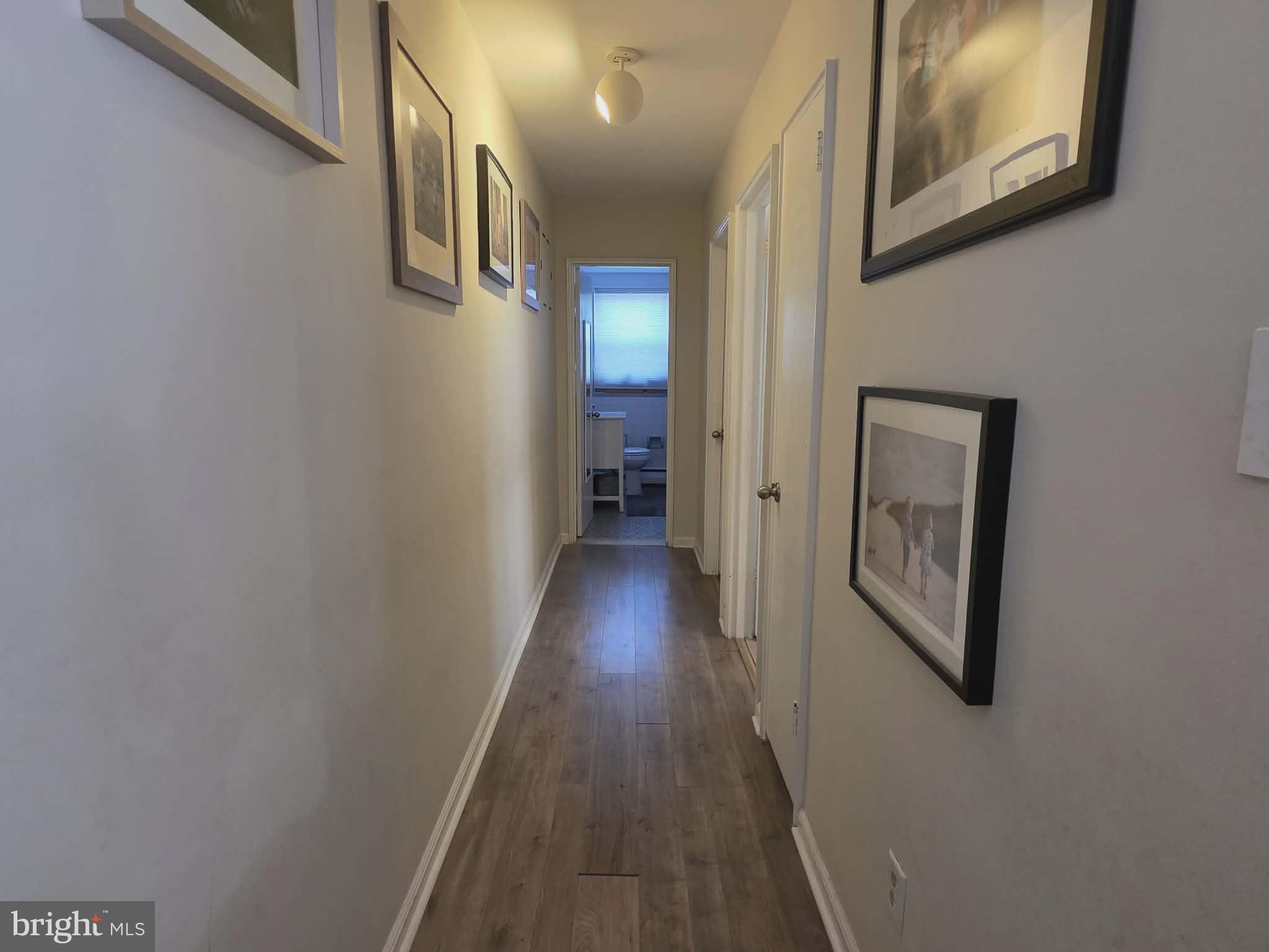 412 North Wayne Avenue, Unit 109 Wayne, PA 19087 - Photo 9 of 20 a view of a hallway with wooden floor