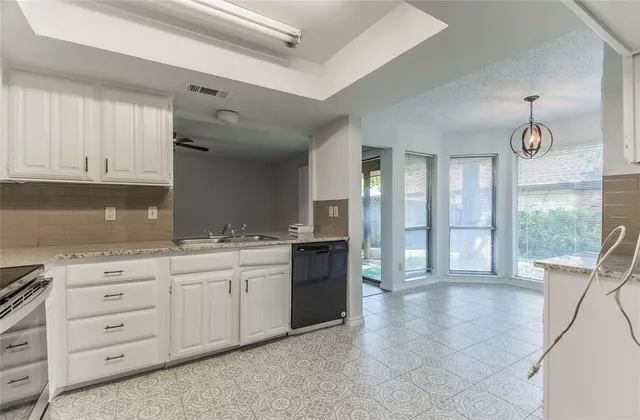 a kitchen with stainless steel appliances a sink and cabinets