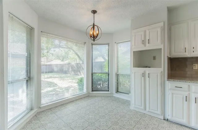 a view of room with window wooden floor and chandelier