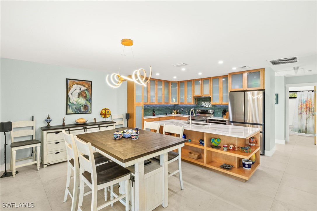 771 Rabbit Road Sanibel, FL 33957 - Photo 12 of 35 a kitchen with a stove a refrigerator and a stove