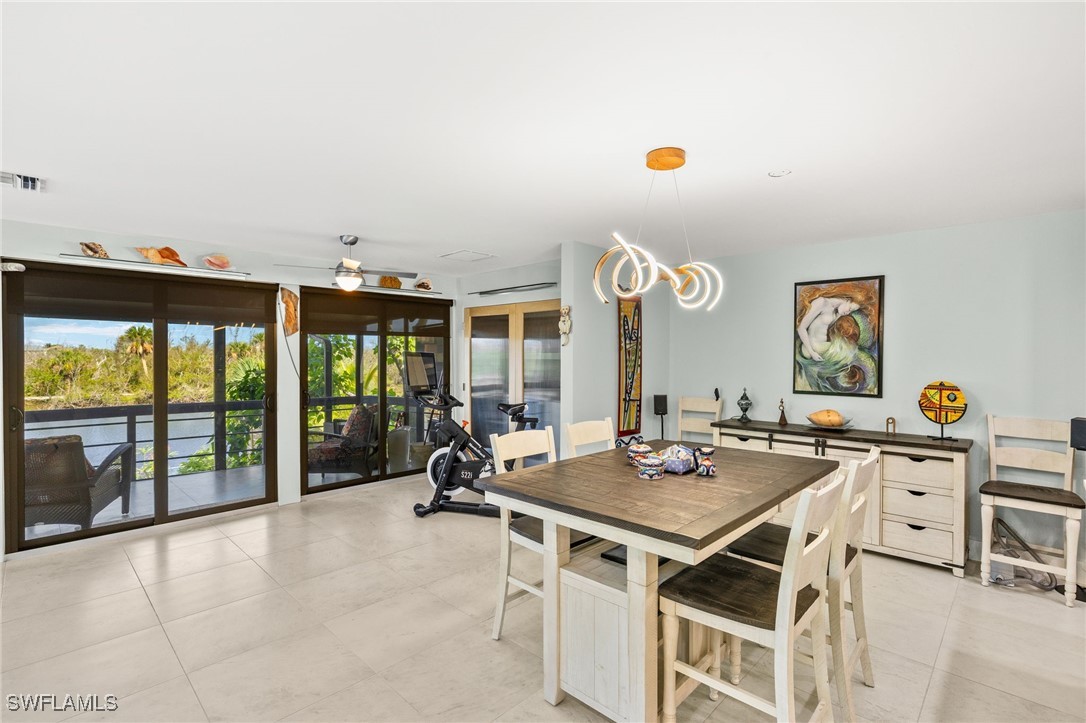 771 Rabbit Road Sanibel, FL 33957 - Photo 13 of 35 a open kitchen with a table and chairs in front of it
