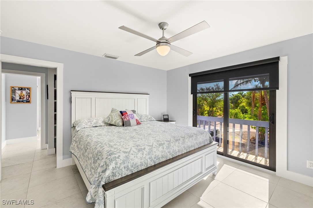 771 Rabbit Road Sanibel, FL 33957 - Photo 14 of 35 a bedroom with a bed and a large window