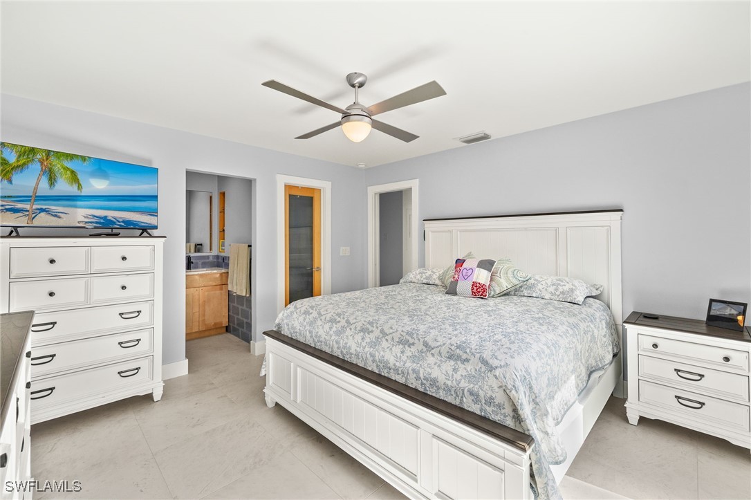 771 Rabbit Road Sanibel, FL 33957 - Photo 15 of 35 a bedroom with a bed and a dresser