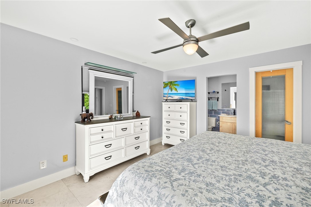 771 Rabbit Road Sanibel, FL 33957 - Photo 16 of 35 a bedroom with a bed and a dresser in it