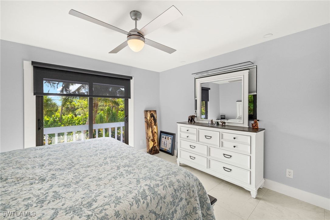 771 Rabbit Road Sanibel, FL 33957 - Photo 17 of 35 a bedroom with a bed and a dresser