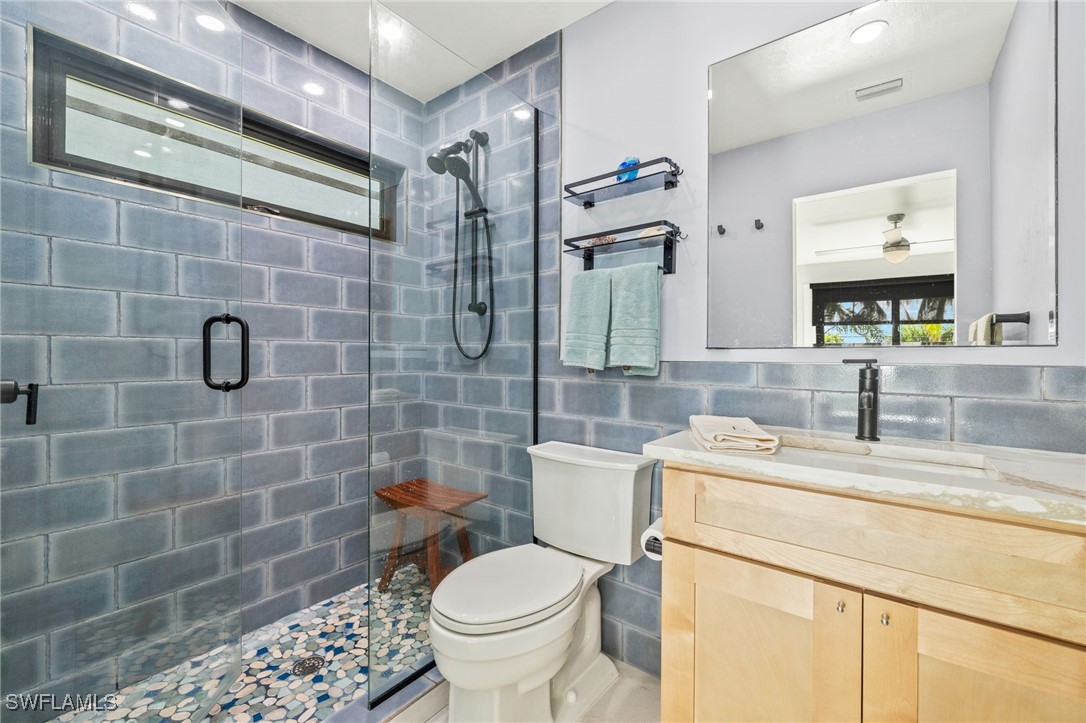 771 Rabbit Road Sanibel, FL 33957 - Photo 18 of 35 a bathroom with a sink a toilet and shower