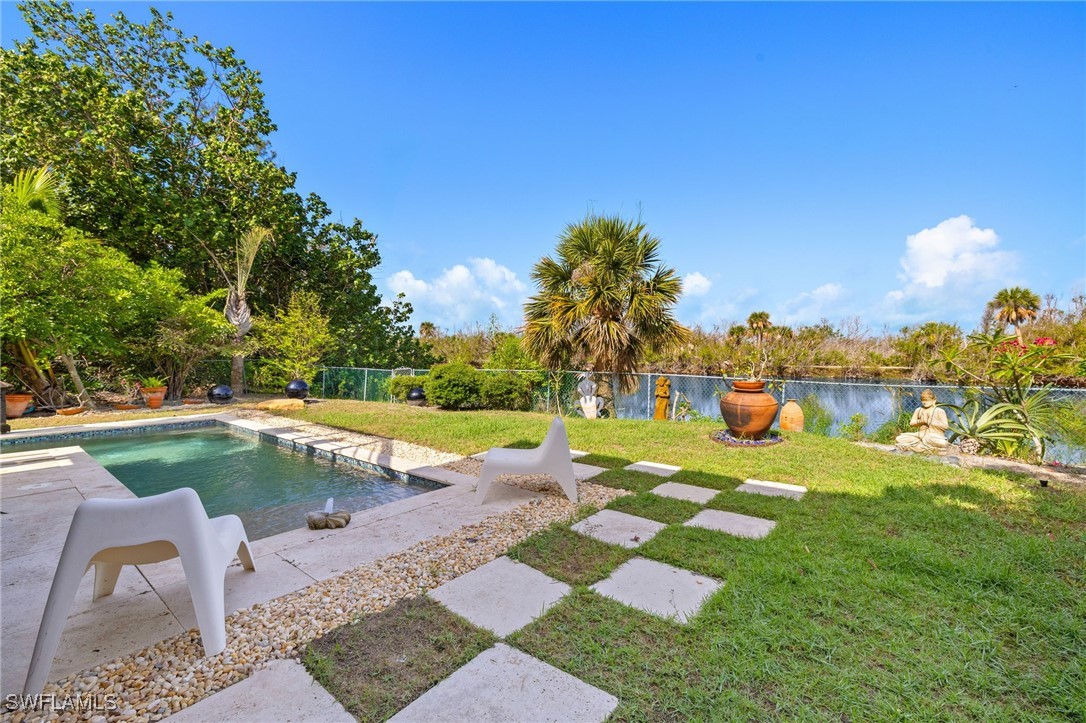 771 Rabbit Road Sanibel, FL 33957 - Photo 26 of 35 a view of a swimming pool with a patio
