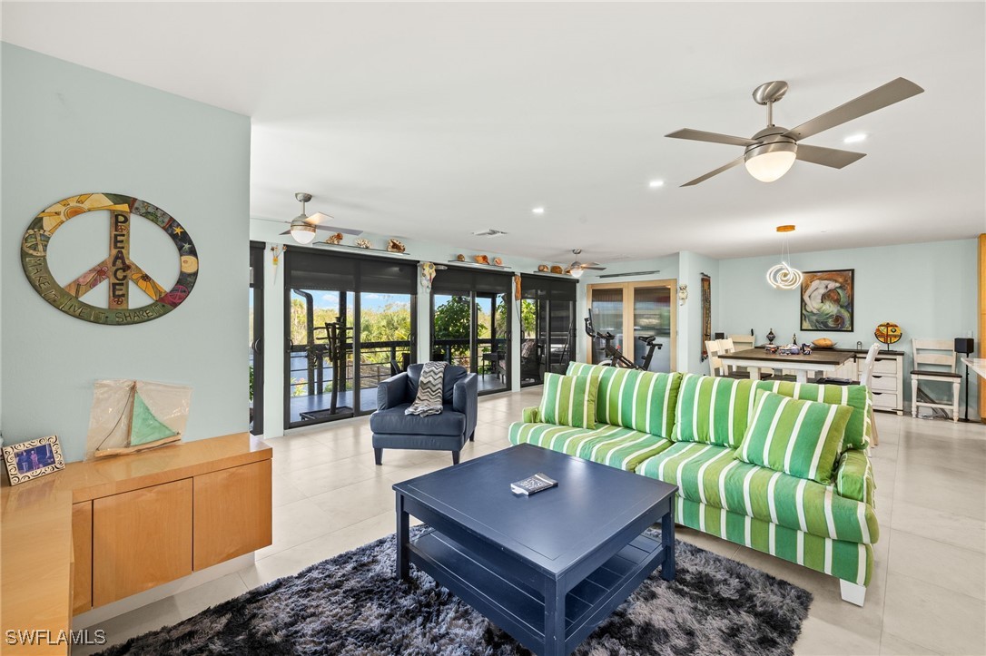771 Rabbit Road Sanibel, FL 33957 - Photo 3 of 35 a living room with furniture a rug and a chandelier
